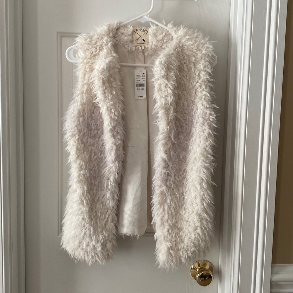 White furry vest.